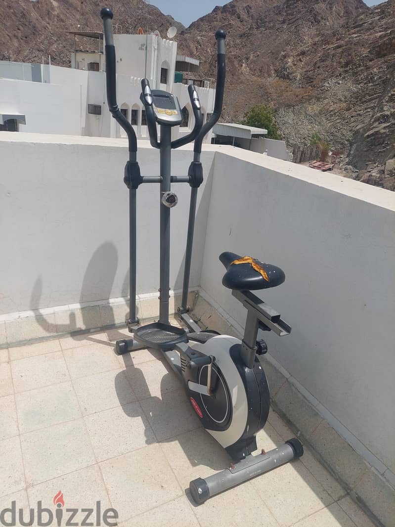 Elliptical cross trainer with an integrated exercise bike seat. 1