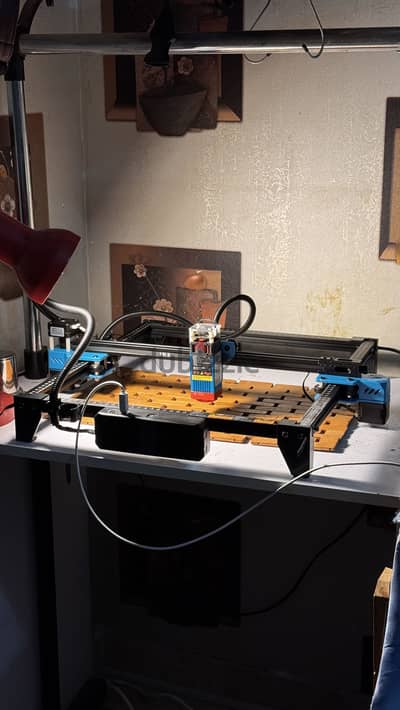 Laser engraver TTS 55 pro with a phone cases stack