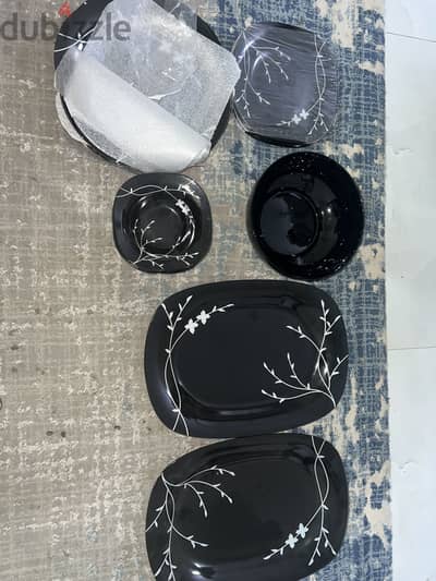 Beautiful black dinner set with elegant white floral design.