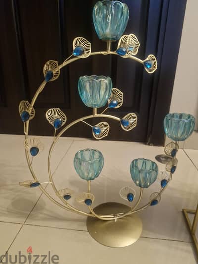 peacock inspired golden metal candle holder