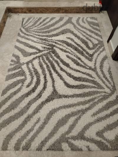modern abstract area rug featuring ivory and grey